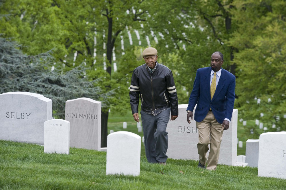 Milton Rowe, left, and Wayne Parks, both descendants of people who lived in Freedman’s Village, walk where the village once stood in Arlington National Cemetery in 2010.