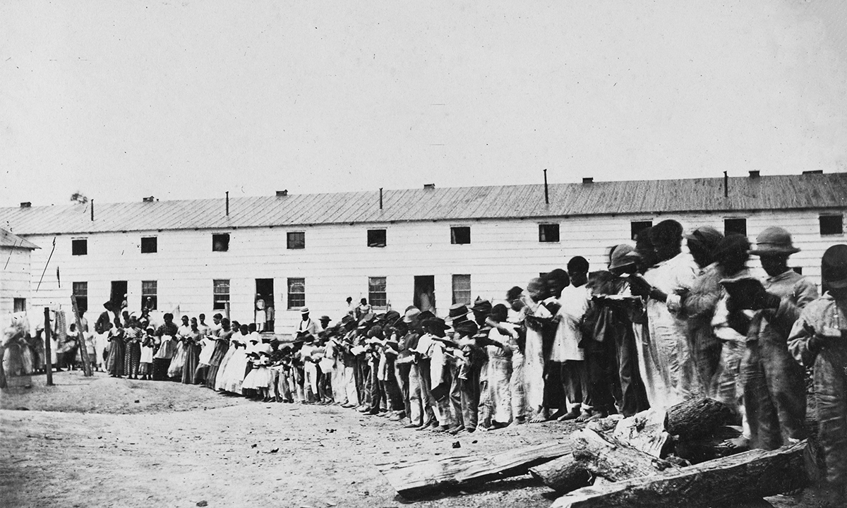 Residents of Freedman’s Village reading books outside their barracks in Arlington, Virginia, between 1863 and 1865.